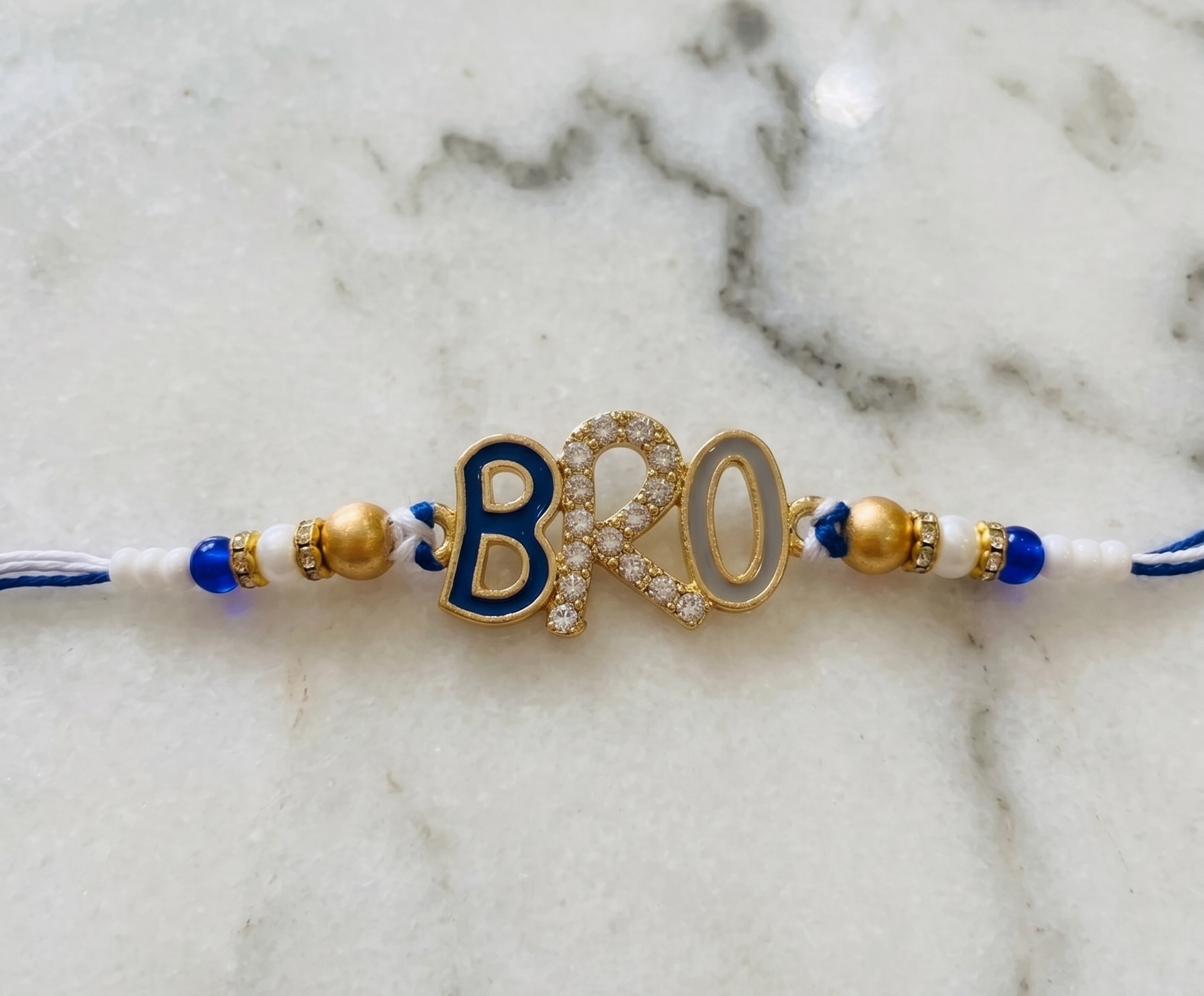 TNT Designs Stylish BRO Letter Rakhi for Brother | Navy Blue Gold Twisted Thread Rakhi with Bead Accents | BRO Design for Brother with Diamond Studded Letters